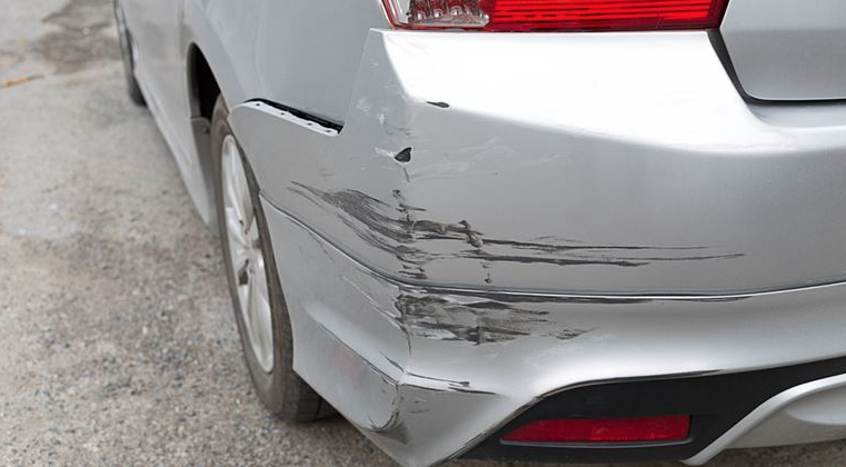 silver car with scratches